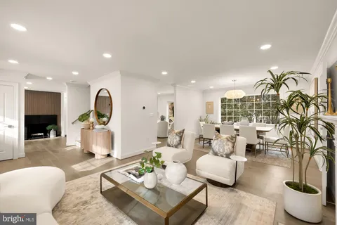 a view of a dining room with furniture a chandelier and wooden floor