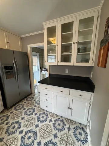 a kitchen with granite countertop a refrigerator and a sink