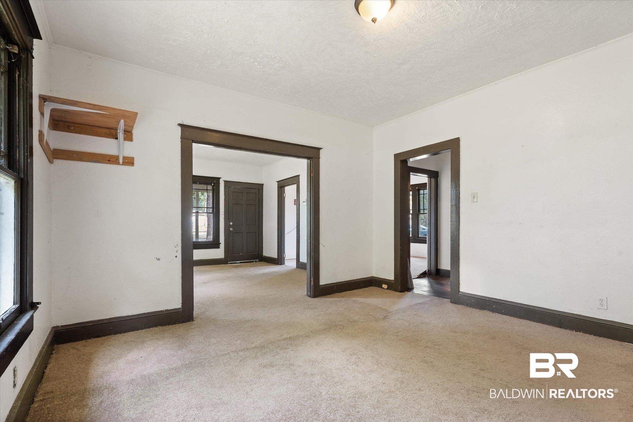 672 Burden Street Mobile, AL 36607 - Photo 5 of 20 Empty room with light colored carpet, baseboards, and a textured ceiling