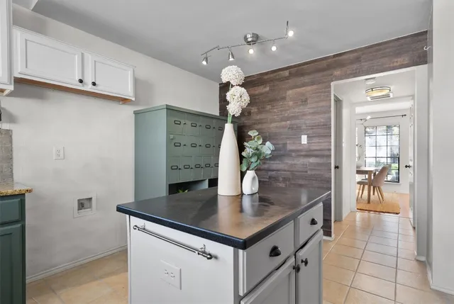 a kitchen with stainless steel appliances granite countertop a sink a refrigerator and a stove