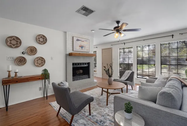 a living room with furniture and a fireplace