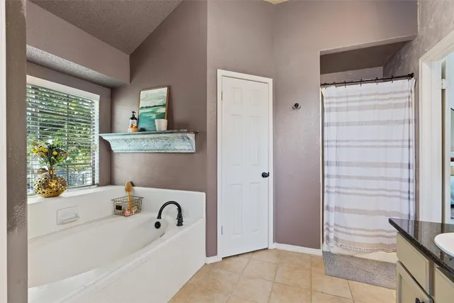a bathroom with a bathtub sink and window