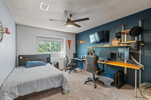 a bedroom with a bed and a desk