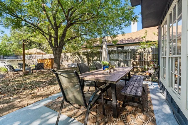 a view of a patio with table and chairs and wooden floor