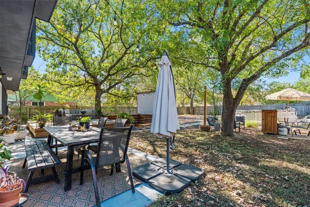 a view of a house with backyard and sitting area