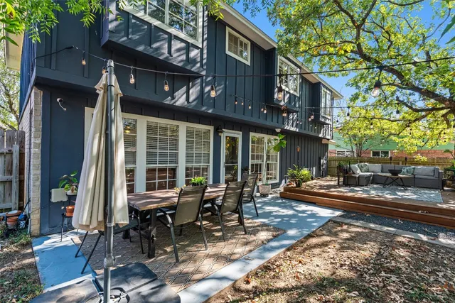 a view of a brick house with chairs in front of building