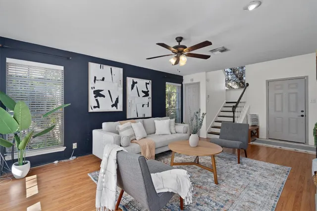 a living room with furniture and wooden floor