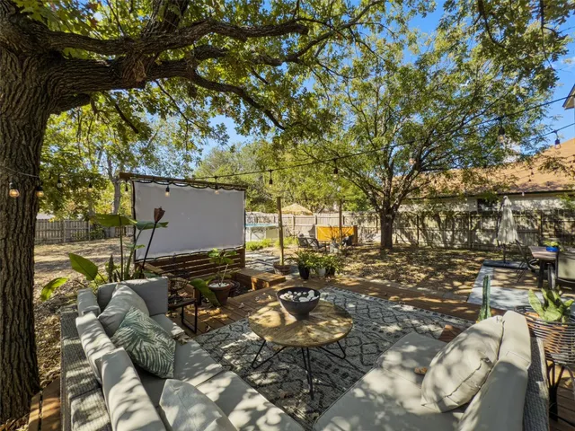 a backyard of a house with table and chairs