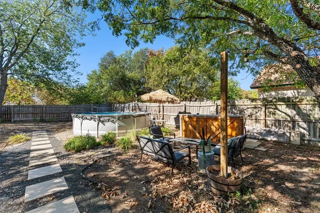 a view of a tables and chairs under an umbrella