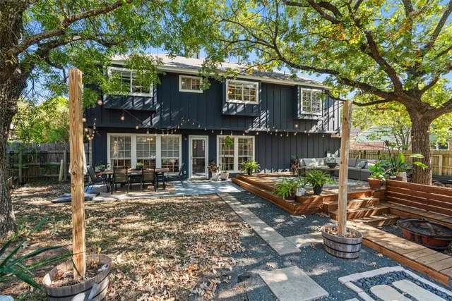 a front view of a house with sitting area and garden