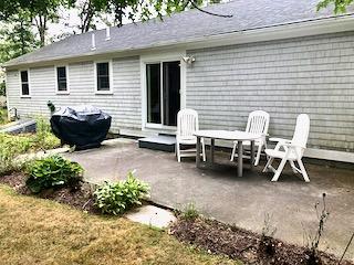 136 East Osterville Road Osterville, MA 02655 - Photo 18 of 22 a view of a chairs and table in backyard of the house