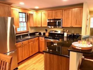 136 East Osterville Road Osterville, MA 02655 - Photo 2 of 22 a kitchen with stainless steel appliances a sink stove refrigerator and cabinets