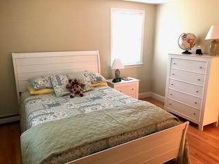 136 East Osterville Road Osterville, MA 02655 - Photo 7 of 22 a bed sitting in a bedroom next to a window with two dresser