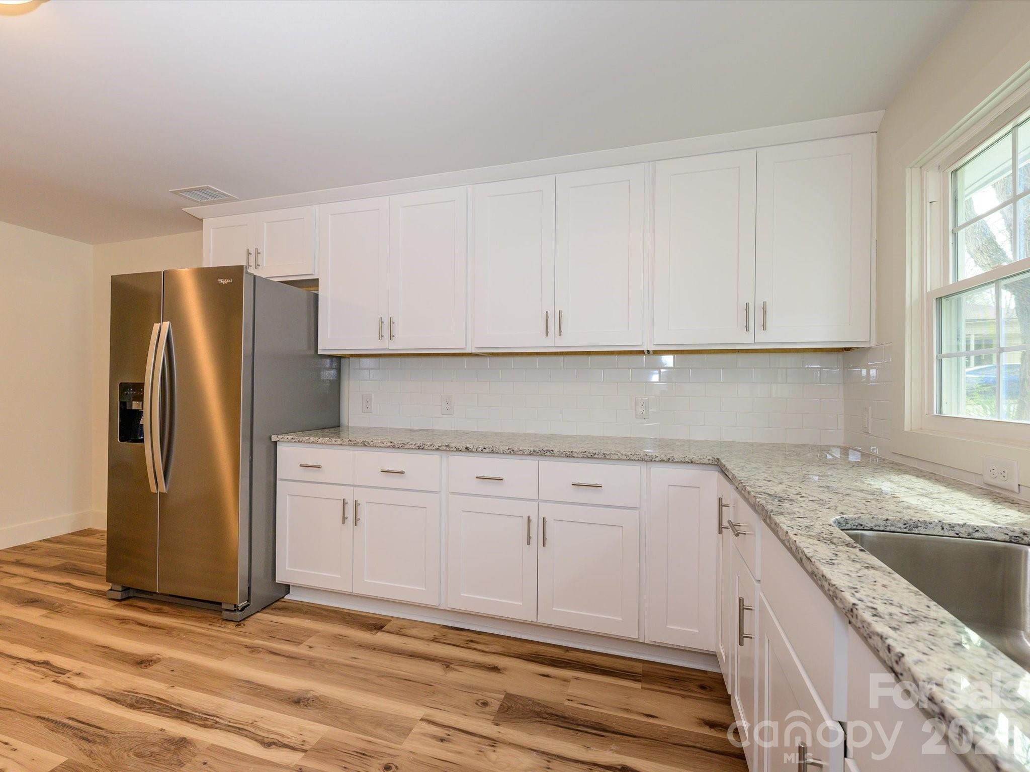 156 Hartsell School Road Southwest Concord, NC 28027 - Photo 13 of 28 a kitchen with granite countertop cabinets stainless steel appliances and a window