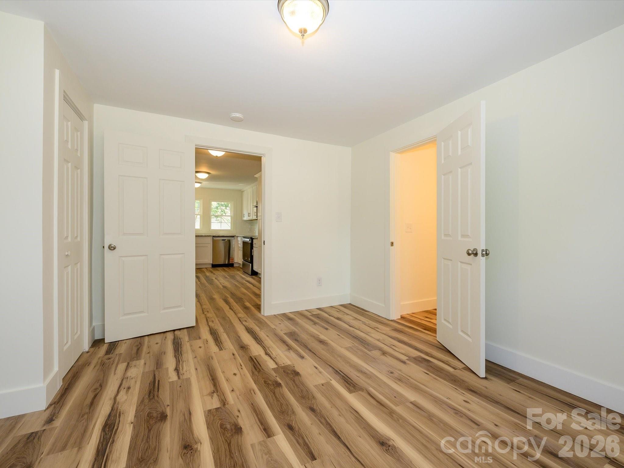 156 Hartsell School Road Southwest Concord, NC 28027 - Photo 16 of 28 a view of a room with wooden floor and a bathroom