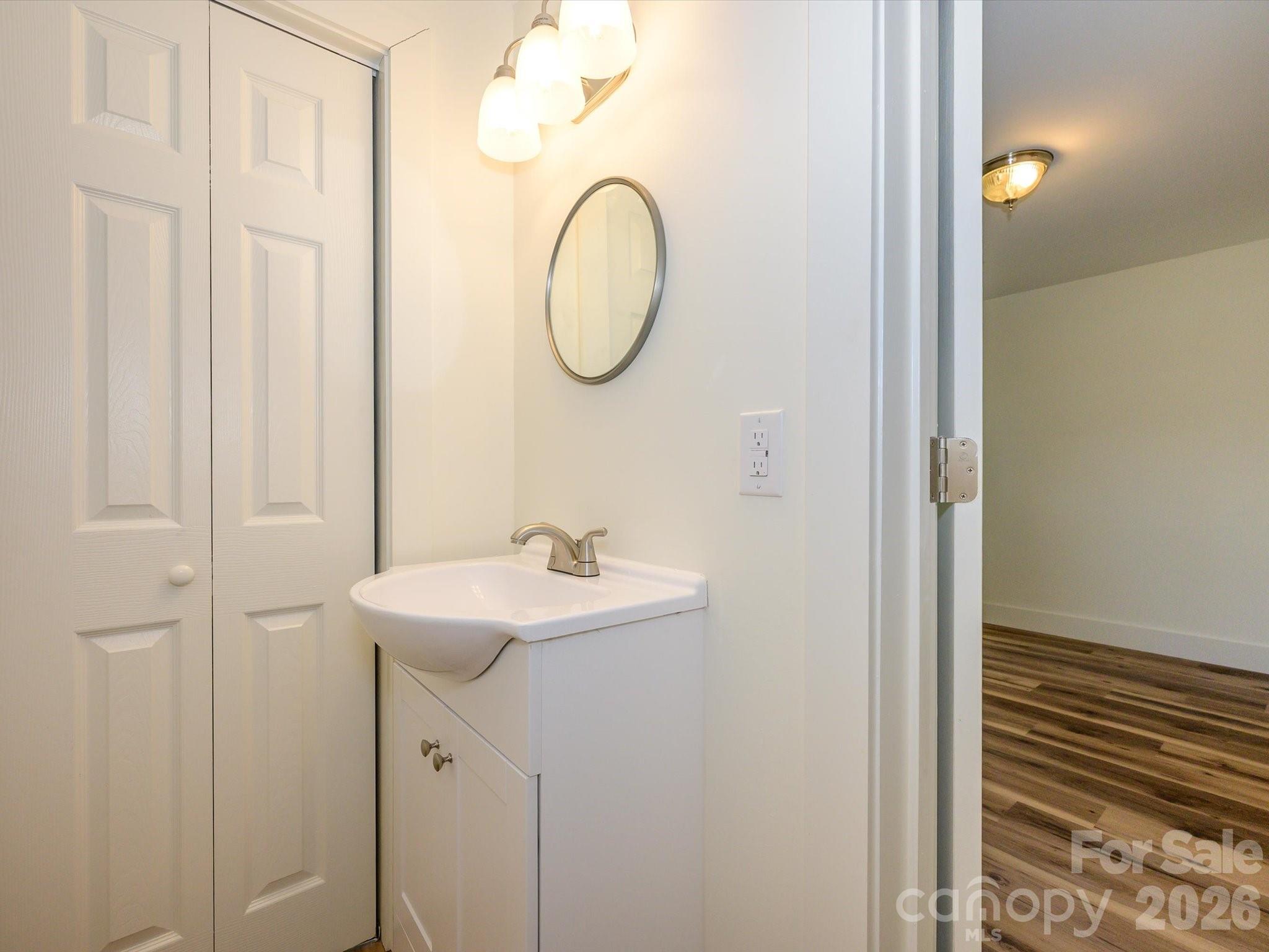 156 Hartsell School Road Southwest Concord, NC 28027 - Photo 18 of 28 a bathroom with a sink and a mirror