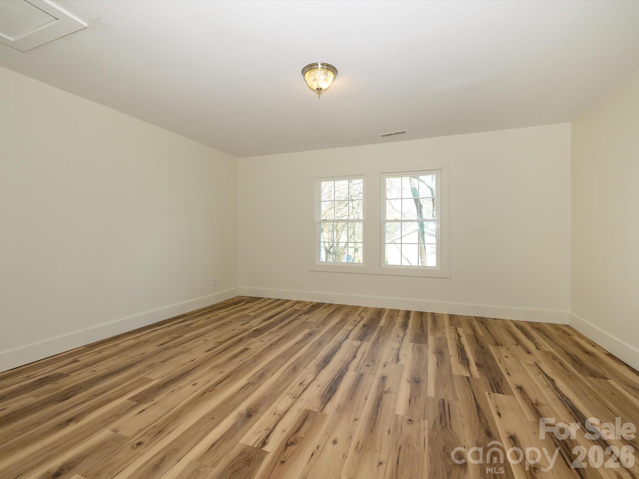 156 Hartsell School Road Southwest Concord, NC 28027 - Photo 21 of 28 wooden floor in an empty room with a window