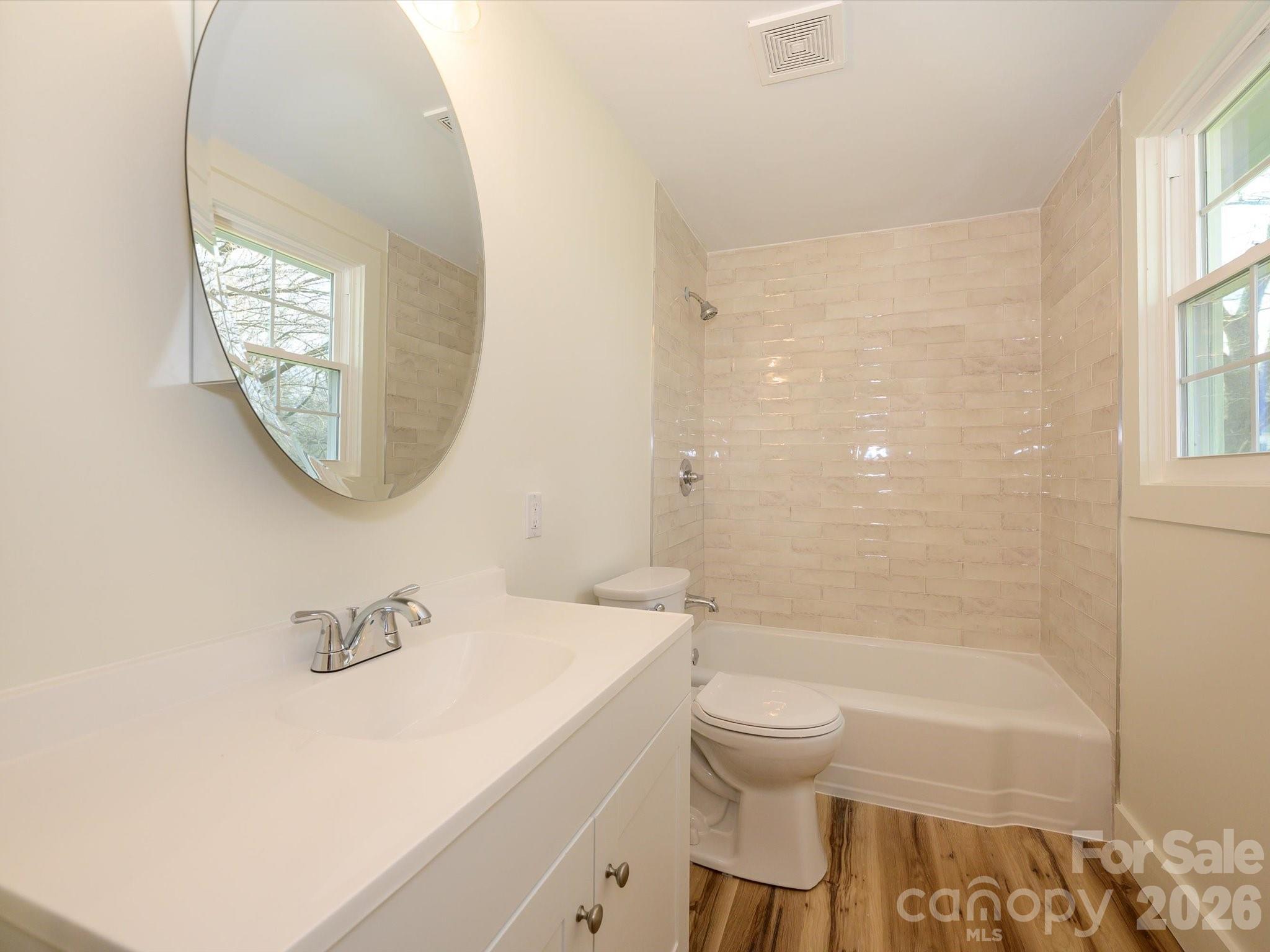 156 Hartsell School Road Southwest Concord, NC 28027 - Photo 23 of 28 a bathroom with a sink a toilet and a mirror