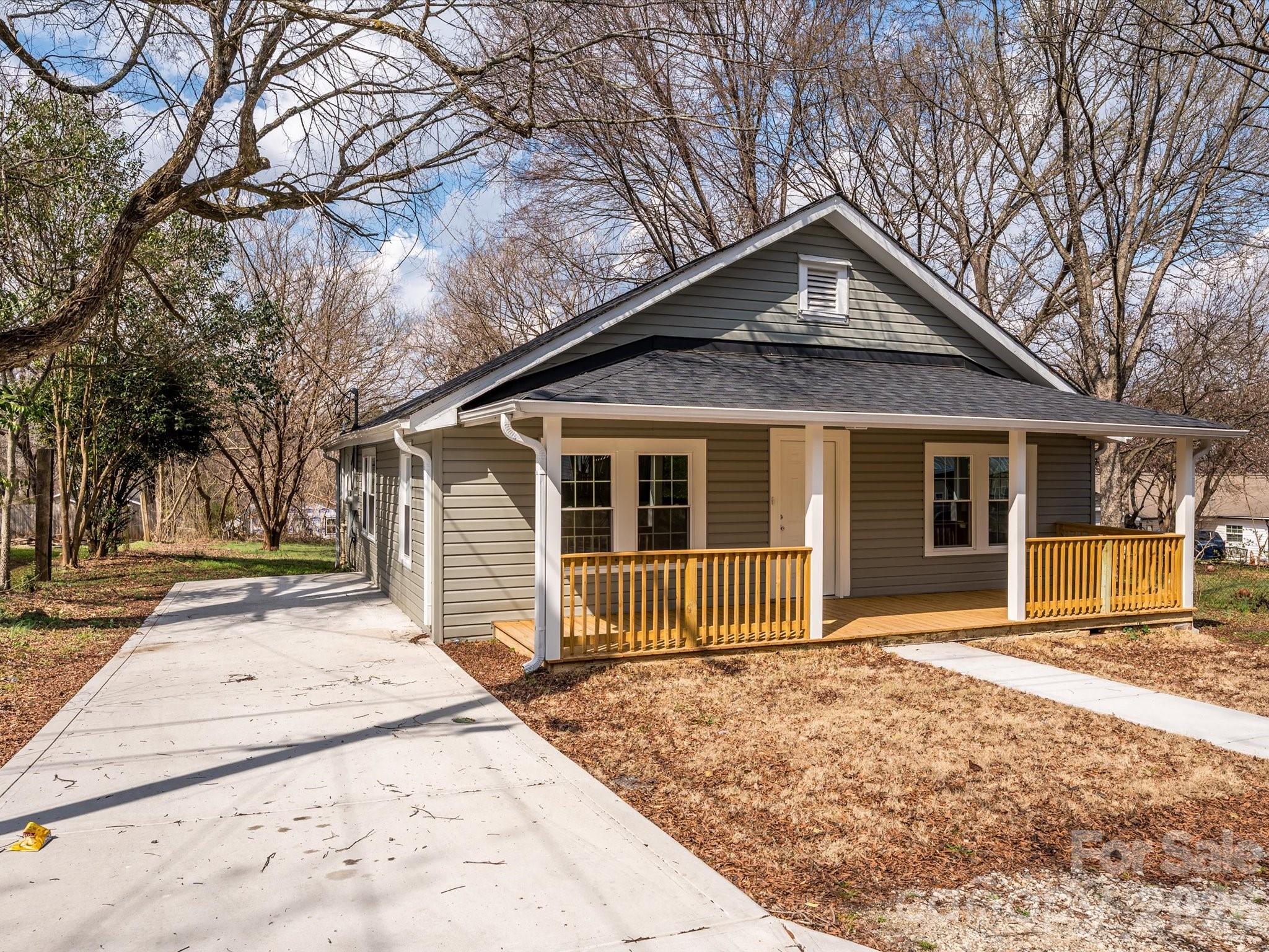 156 Hartsell School Road Southwest Concord, NC 28027 - Photo 28 of 28 a front view of a house with a yard and garage