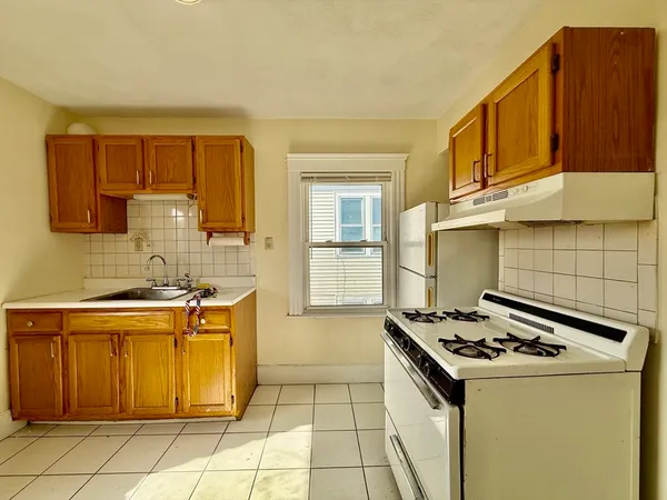 a kitchen with a stove a sink and a refrigerator