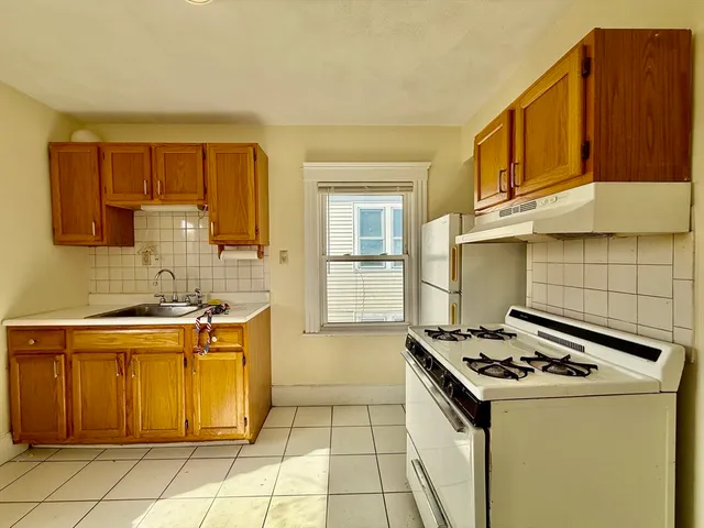 a kitchen with a stove a sink and a refrigerator