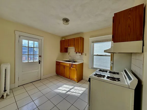 a kitchen with a stove a sink and a cabinets