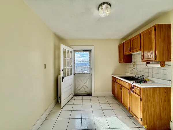 a kitchen with a stove a sink and a refrigerator