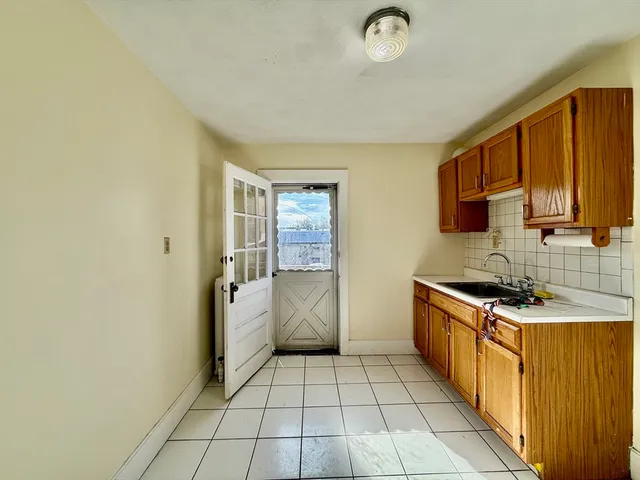 a kitchen with a stove a sink and a refrigerator