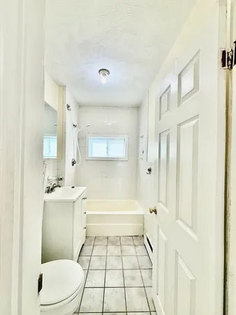 a bathroom with a sink a toilet a mirror and a bathtub