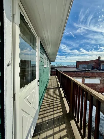 a view of balcony with wooden floor