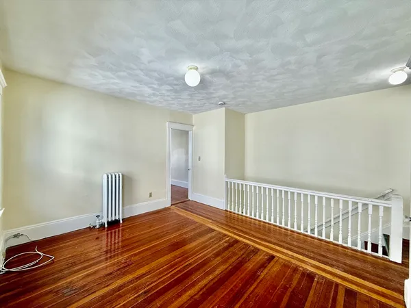a view of a room with wooden floor