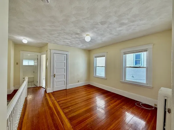 a view of a room with wooden floor and window