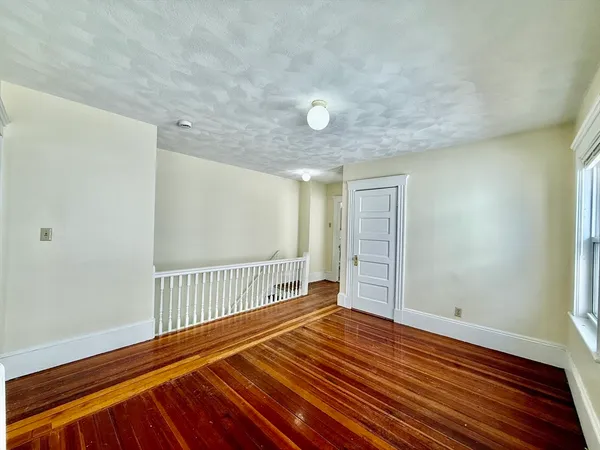 a view of a room with wooden floor