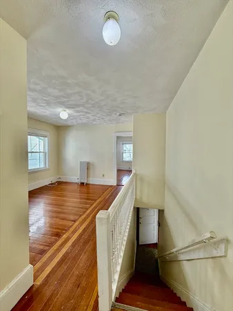 a view of a room with wooden floor and staircase