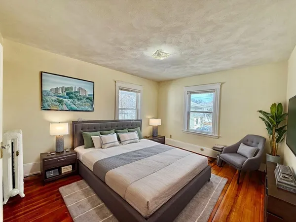 a bedroom with a large bed and a window