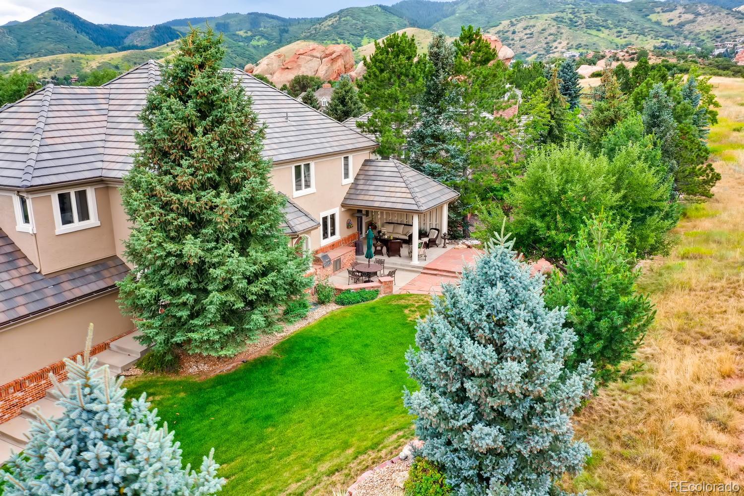 an aerial view of a house with garden space and a patio