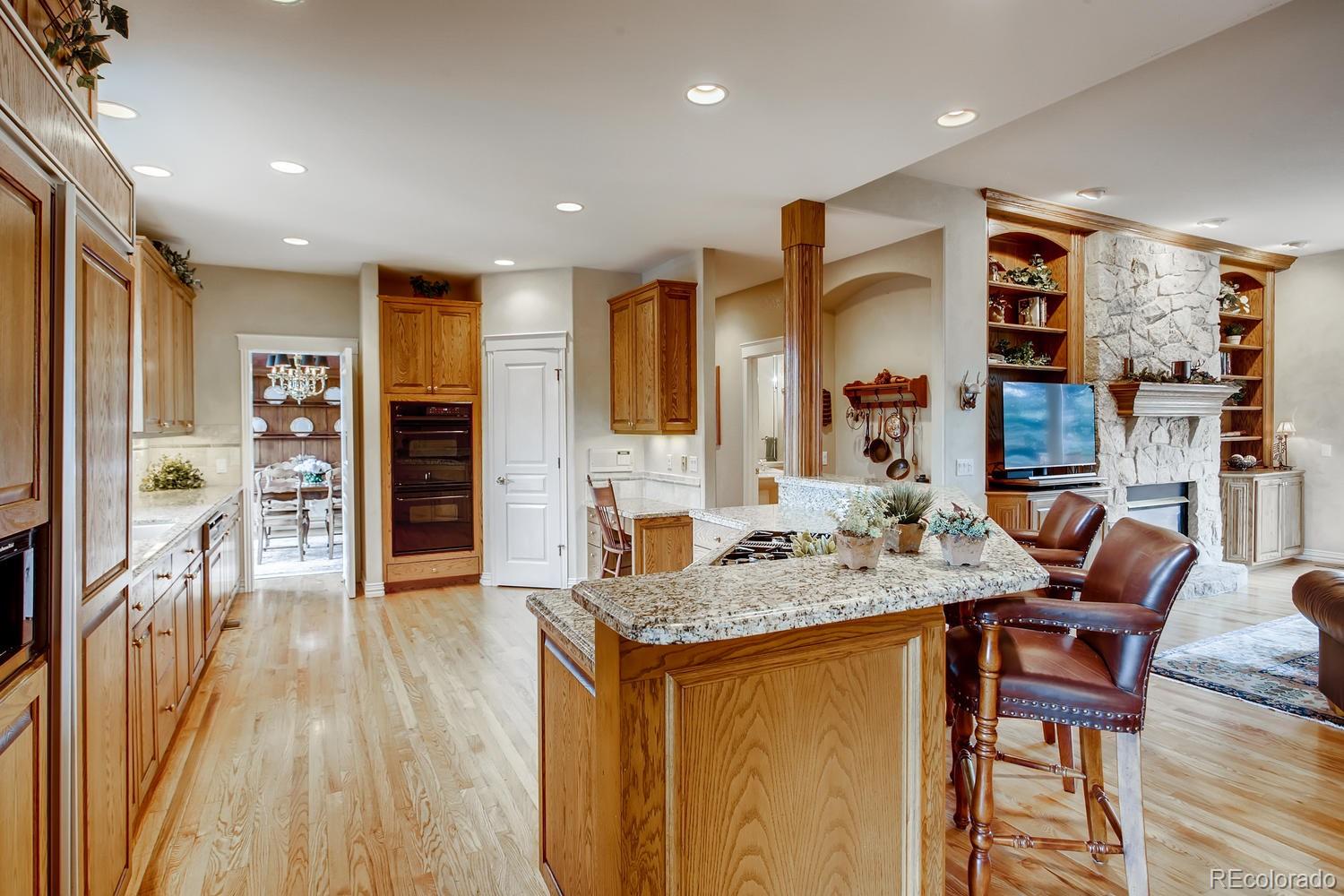 75 North Ranch Road Littleton, CO 80127 - Photo 11 of 33 a kitchen with stainless steel appliances granite countertop a refrigerator and a stove top oven