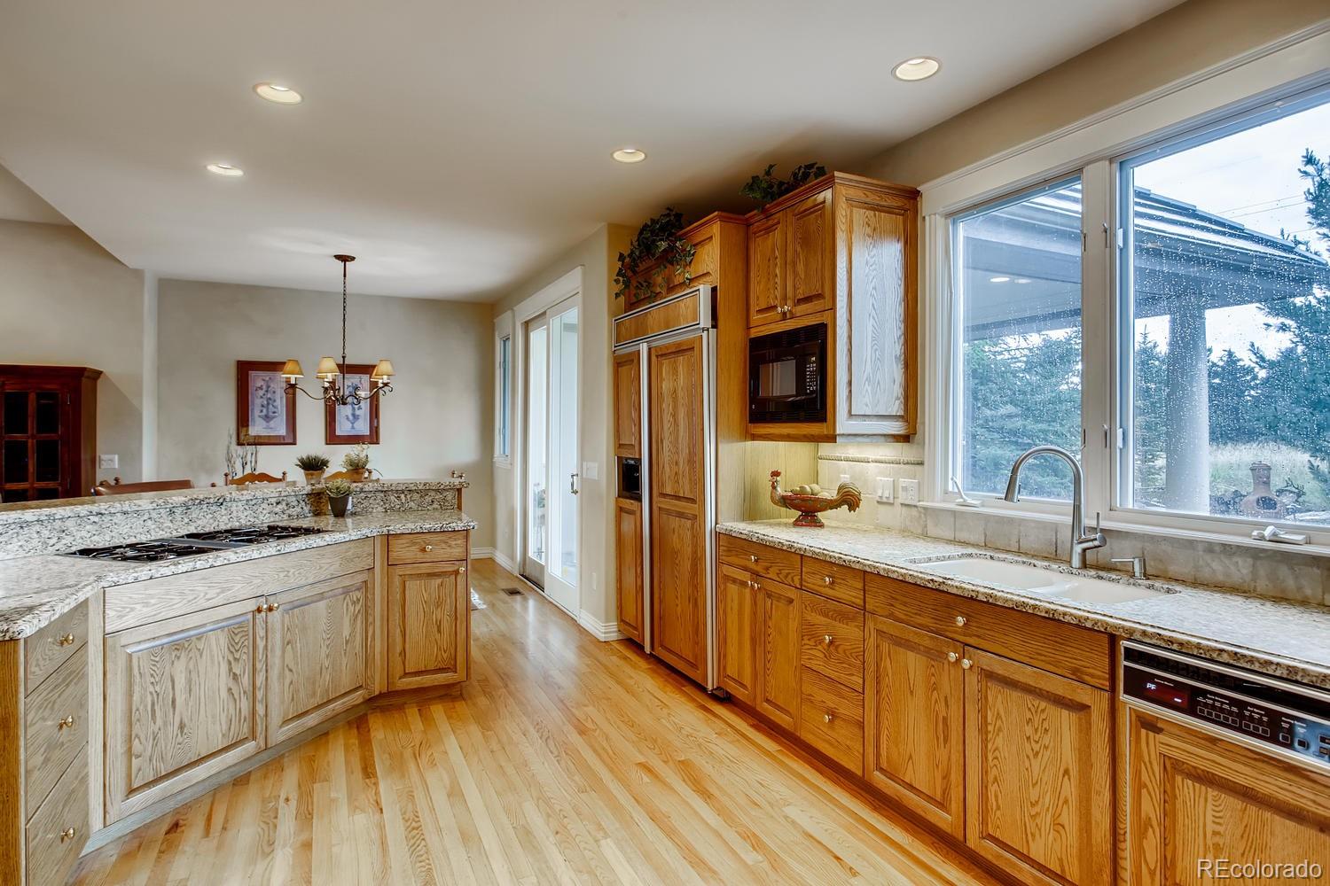 75 North Ranch Road Littleton, CO 80127 - Photo 13 of 33 a large kitchen with a large window and stainless steel appliances