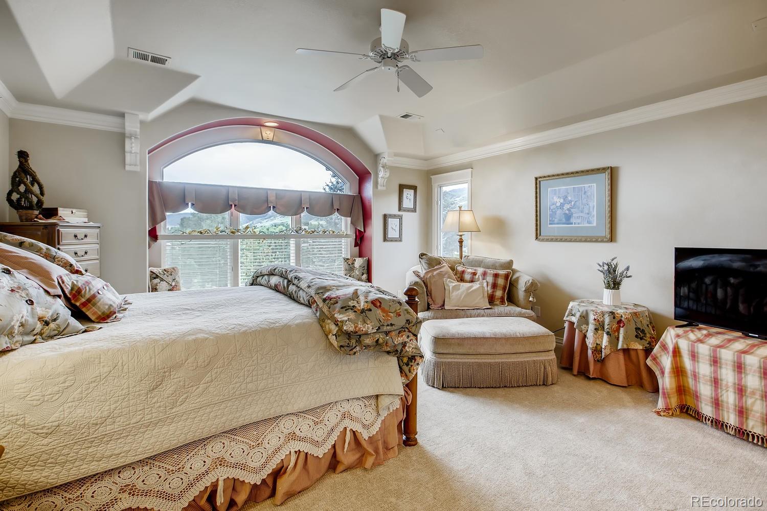 75 North Ranch Road Littleton, CO 80127 - Photo 19 of 33 a bedroom with furniture and a large window