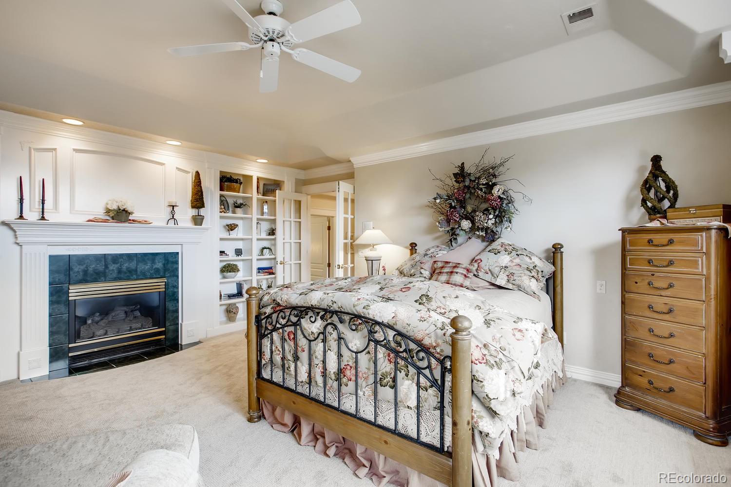 75 North Ranch Road Littleton, CO 80127 - Photo 20 of 33 a bed room with a bed and a fireplace