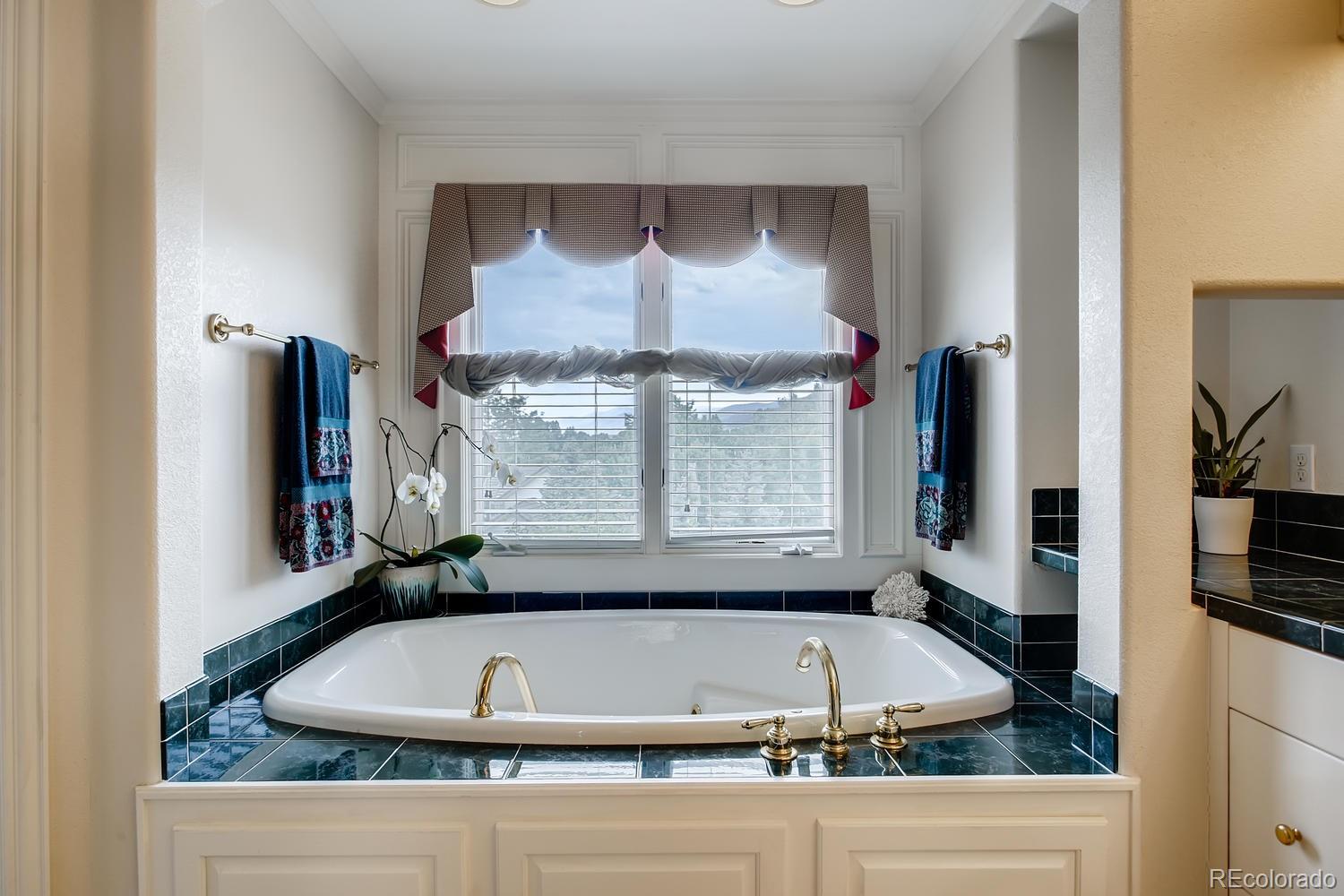 75 North Ranch Road Littleton, CO 80127 - Photo 21 of 33 a bathroom with a bathtub and a sink