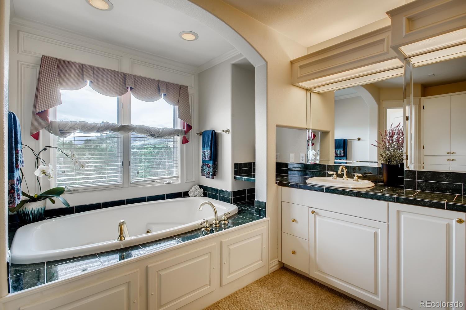 75 North Ranch Road Littleton, CO 80127 - Photo 22 of 33 a kitchen with white cabinets and a sink