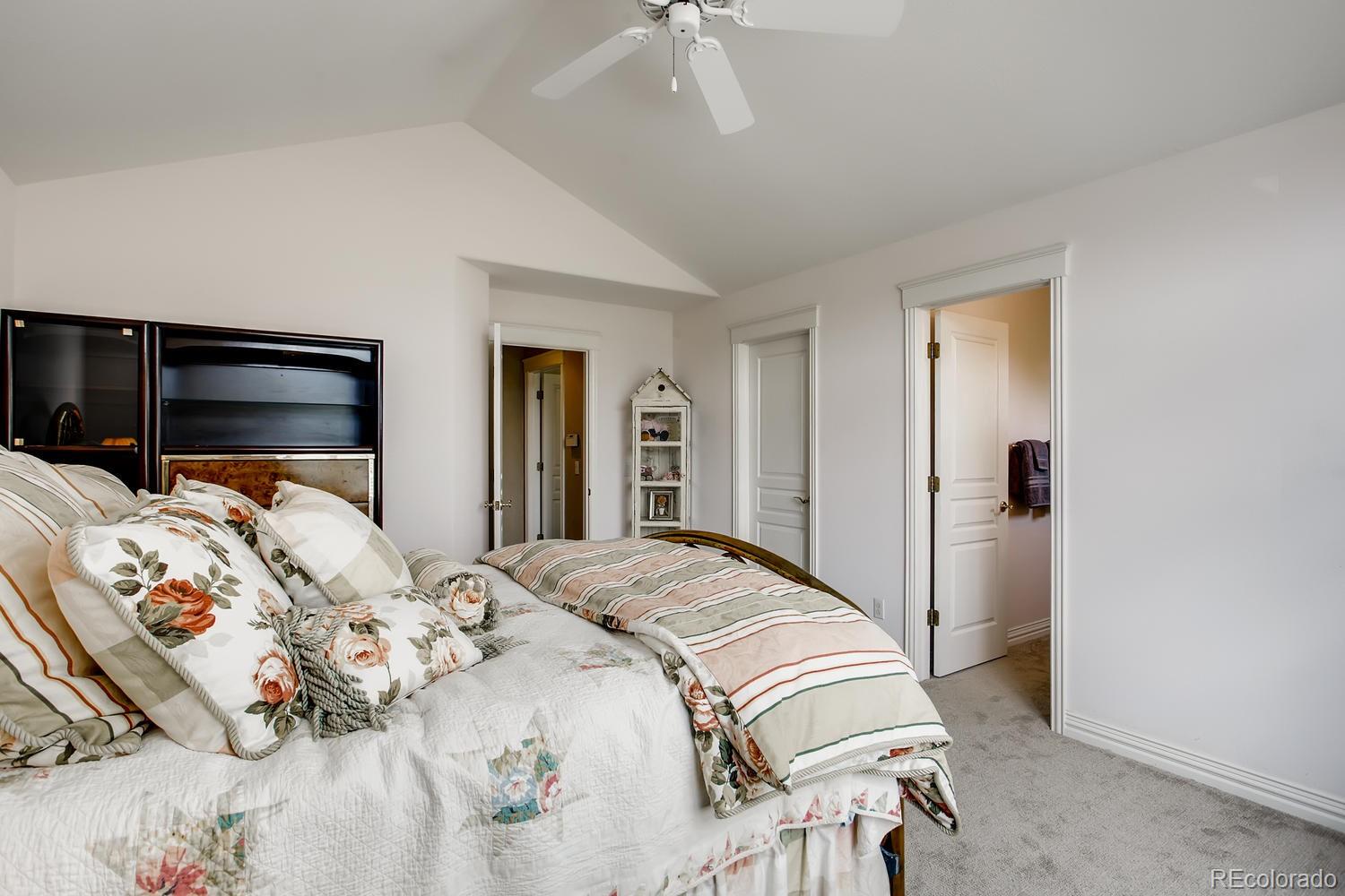 75 North Ranch Road Littleton, CO 80127 - Photo 25 of 33 a bedroom with a bed and a ceiling fan