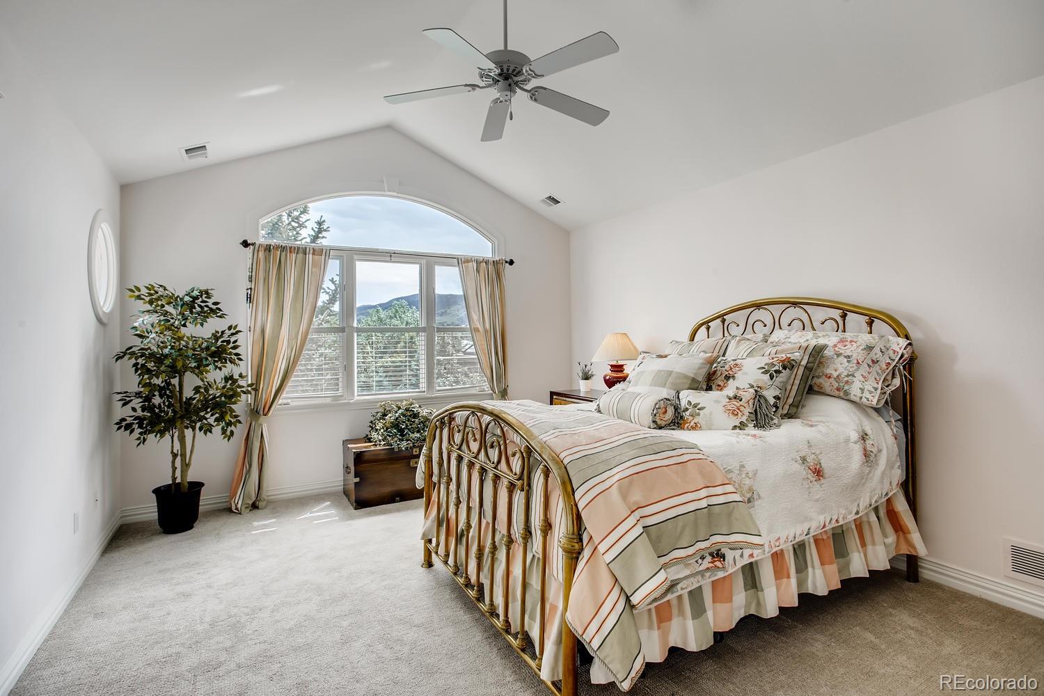 75 North Ranch Road Littleton, CO 80127 - Photo 26 of 33 a bedroom with a bed and a chandelier