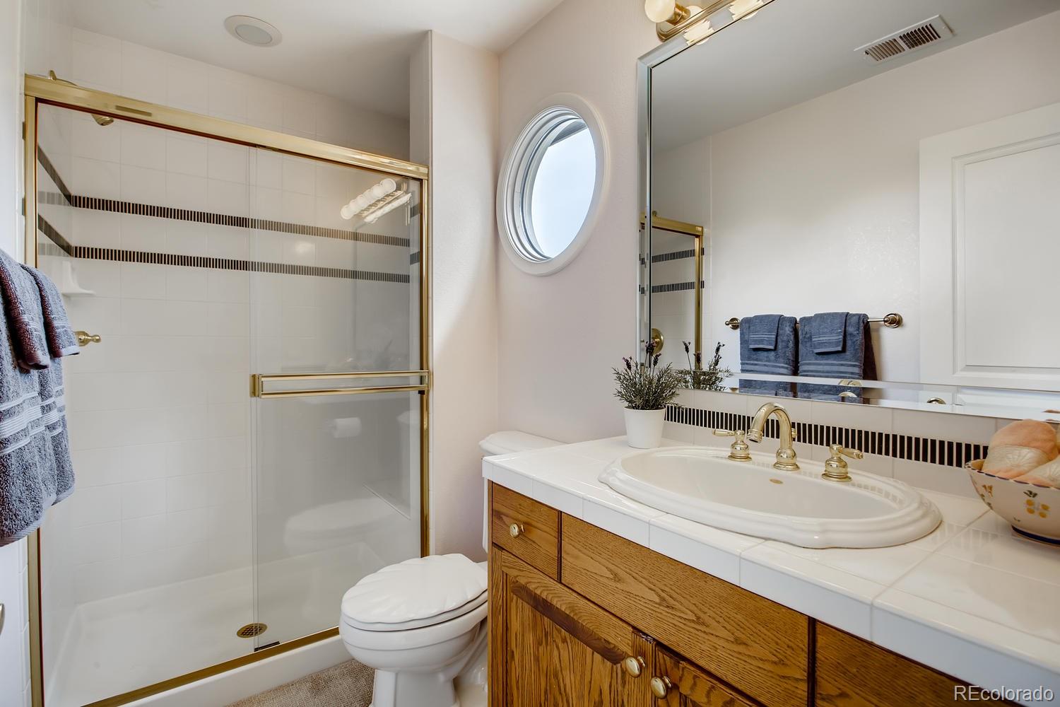 75 North Ranch Road Littleton, CO 80127 - Photo 27 of 33 a bathroom with a sink toilet and a mirror