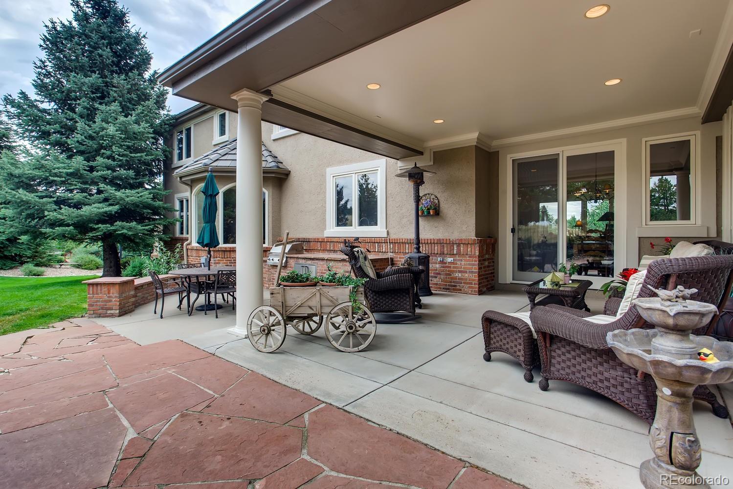 75 North Ranch Road Littleton, CO 80127 - Photo 3 of 33 a living room with patio furniture and a garden