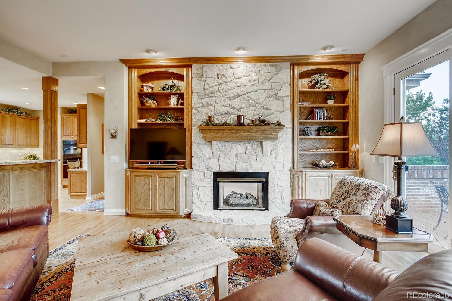 75 North Ranch Road Littleton, CO 80127 - Photo 7 of 33 a living room with furniture fireplace and flat screen tv