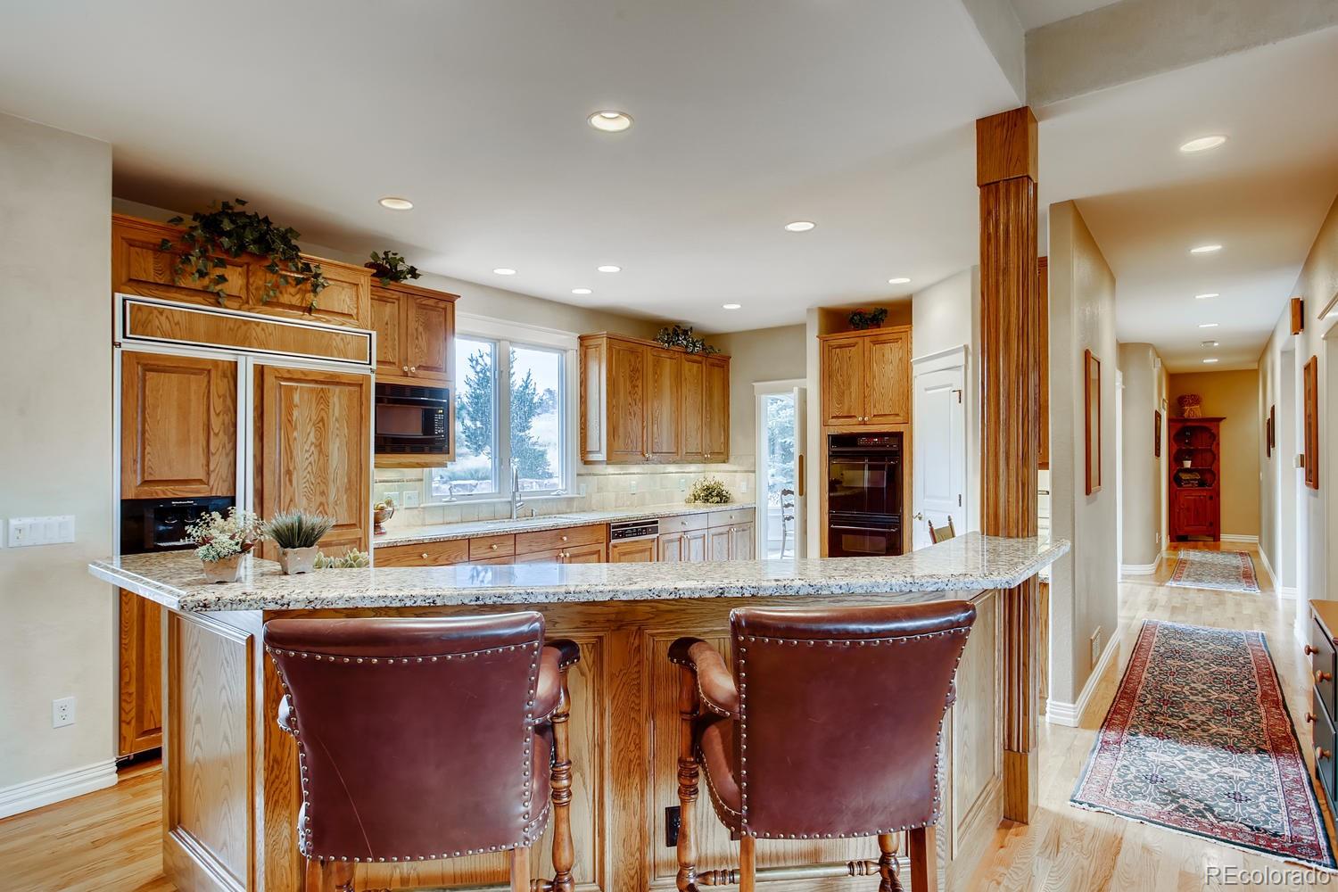 75 North Ranch Road Littleton, CO 80127 - Photo 10 of 33 a kitchen with stainless steel appliances granite countertop a sink and a refrigerator