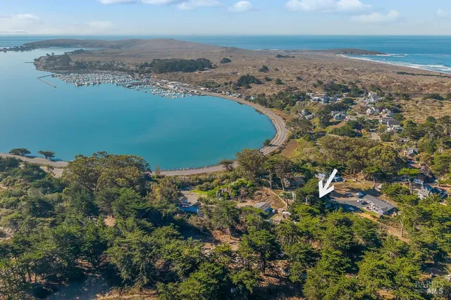 an aerial view of ocean with residential house with outdoor space