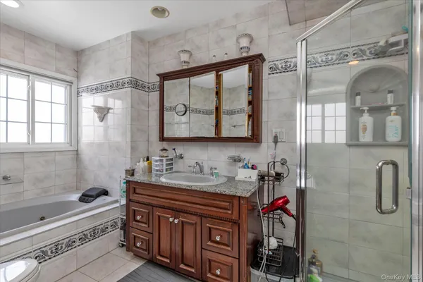 a bathroom with a double vanity sink mirror and shower